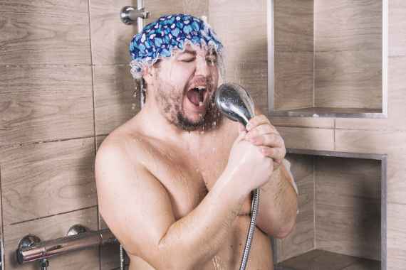 Funny fat man sings in the shower.
