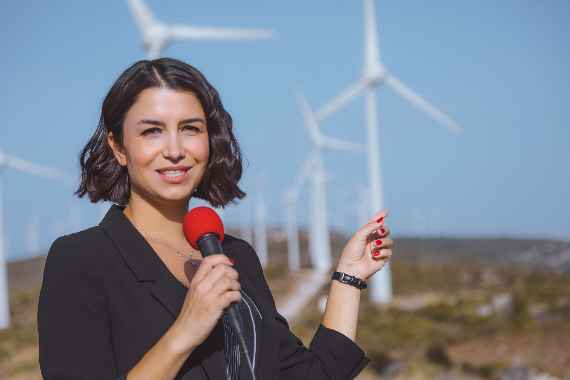 TV news reporter woman making reportage about a renewable energy