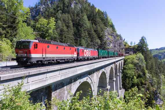Austrian OEBB cargo train passing a viaduct