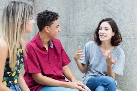 Three caucasian young adults in discussion