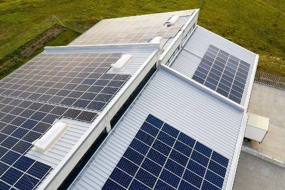 Solar Panel Photovoltaic Installation on Roof of Modern Building