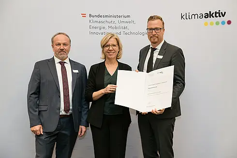 Auszeichnung von klimaaktiv Vorzeigebetrieb König GmbH & Co KG König durch Klimaschutzministerin Leonore Gewessler (BMK). Im Bild: Christoph Hackl (Geschäftsführer / CCO) (rechts), Manfred Faßwald (Leitung Haus- und Betriebstechnik) (links) mit Klimaschutzministerin Leonore Gewessler (BMK) (mitte)