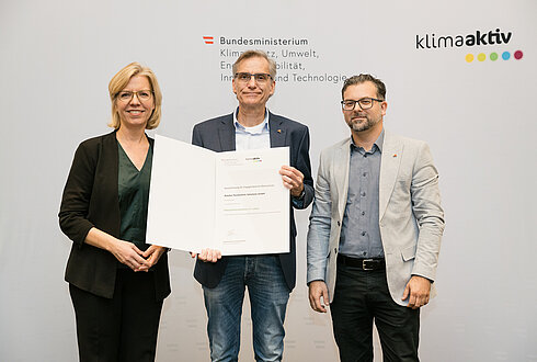 Auszeichnung von klimaaktiv Vorzeigebetrieb Astotec Pyrotechnic Solutions GmbH und Vorzeigebetrieben durch Klimaschutzministerin Leonore Gewessler (BMK). Im Bild Klimaschutzministerin Leonore Gewessler (BMK) (links), Franz Kain (Facility Manager) (mitte) und Christian Gautreaux (Team Leader Building Technology) (rechts)