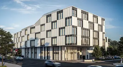 großes helles Gebäude mit großen Fenstern, angeordnet wie ein Schachbrett