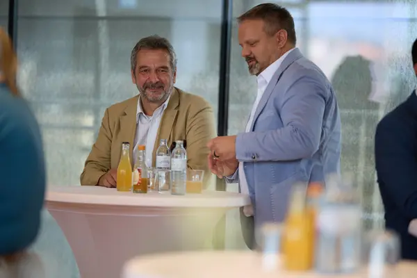 Besucher:innen einer Veranstaltung unterhalten sich