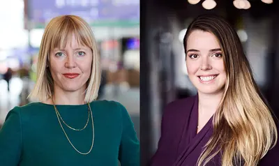 Porträtaufnahme von zwei Personen nebeneinander: Links ist Katharina Helm und rechts Nora Stehmann. Beide sind in einem Innenraum aufgenommen, jeweils vor unscharfem Hintergrund, und blicken in Richtung der Kamera.