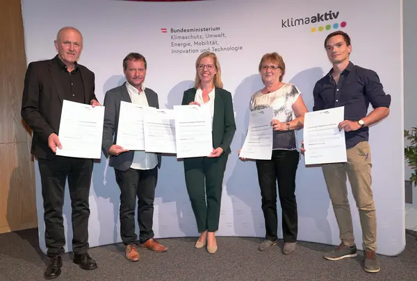 Im Bild: Klimaschutzministerin Leonore Gewessler, Tobias Schmerlaib und Wolfram Stöby (Fortschritt Gemeinnützige Bau-, Wohnungs- und Siedlungsgenossenschaft für Kärnten), Martha und Wolfgang Gärtner (Gärnter Architekten)