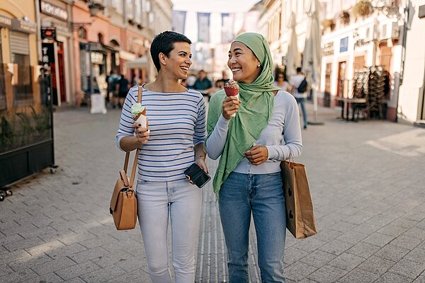 Zwei Frauen in einer Altstadt mit zwei Eis in der Hand