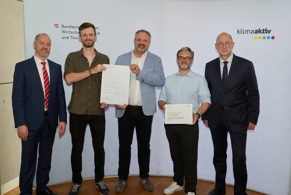 5 Personen mit Urkunde schauen in die Kamera