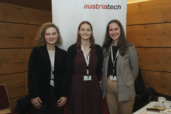 Drei Frauen posieren vor einem Rollup